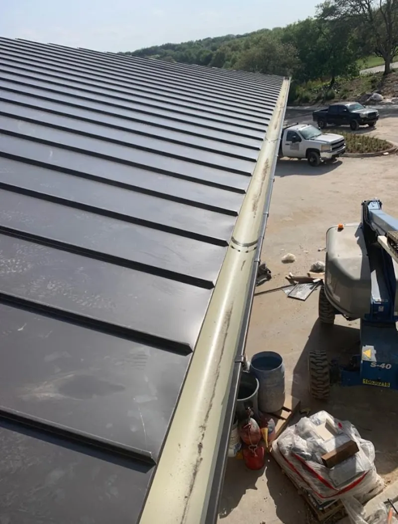 Standing seam panel and gutter detail on a metal roofing jobsite in Myrtletown